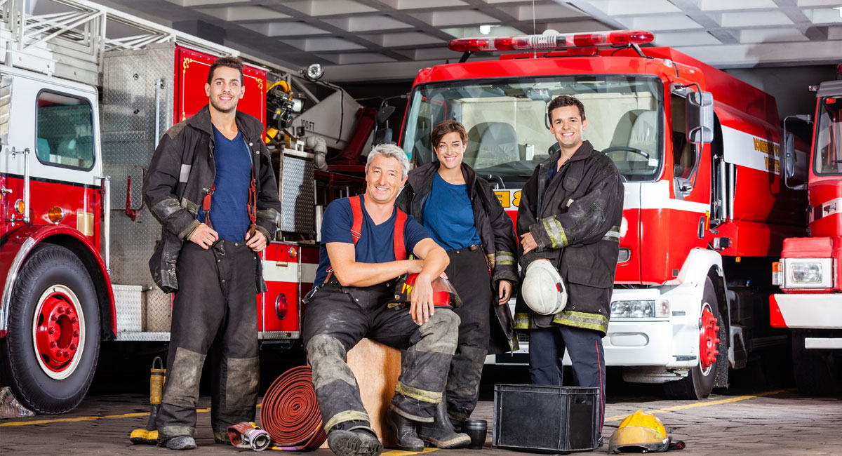 Firefighters standing together at their station